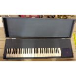 A vintage black cased organ keyboard