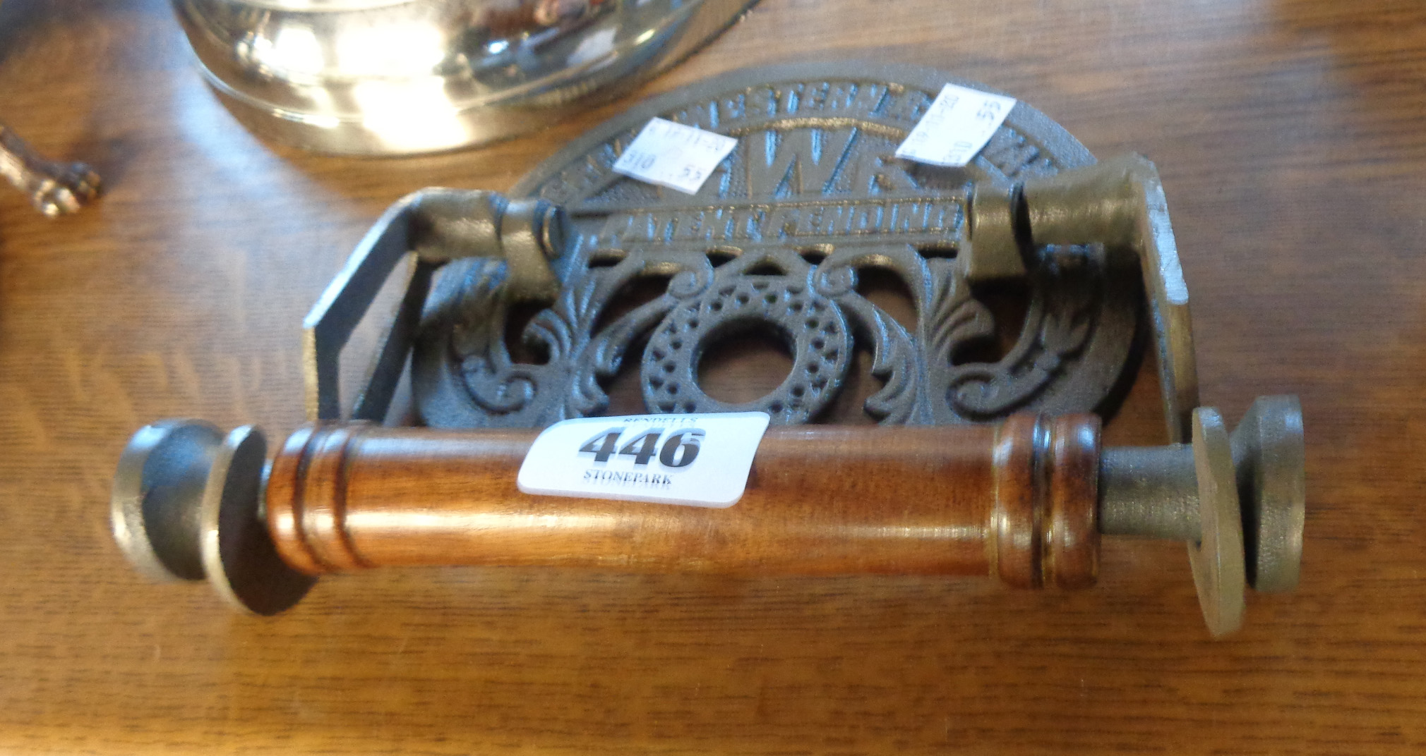 A reproduction cast iron and wood GWR toilet roll holder