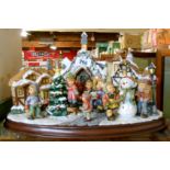 A Danbury Mint MJ Hummel Christmas Village with certificate