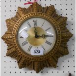 A vintage gilt plaster starburst wall timepiece with Smiths eight day floating balance movement