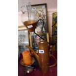 A wrought iron and copper wine carafe with glass vessel, a hammered copper coffee pot, and a