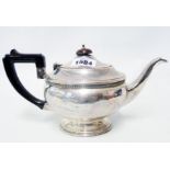 A silver teapot with Bakelite knob handle