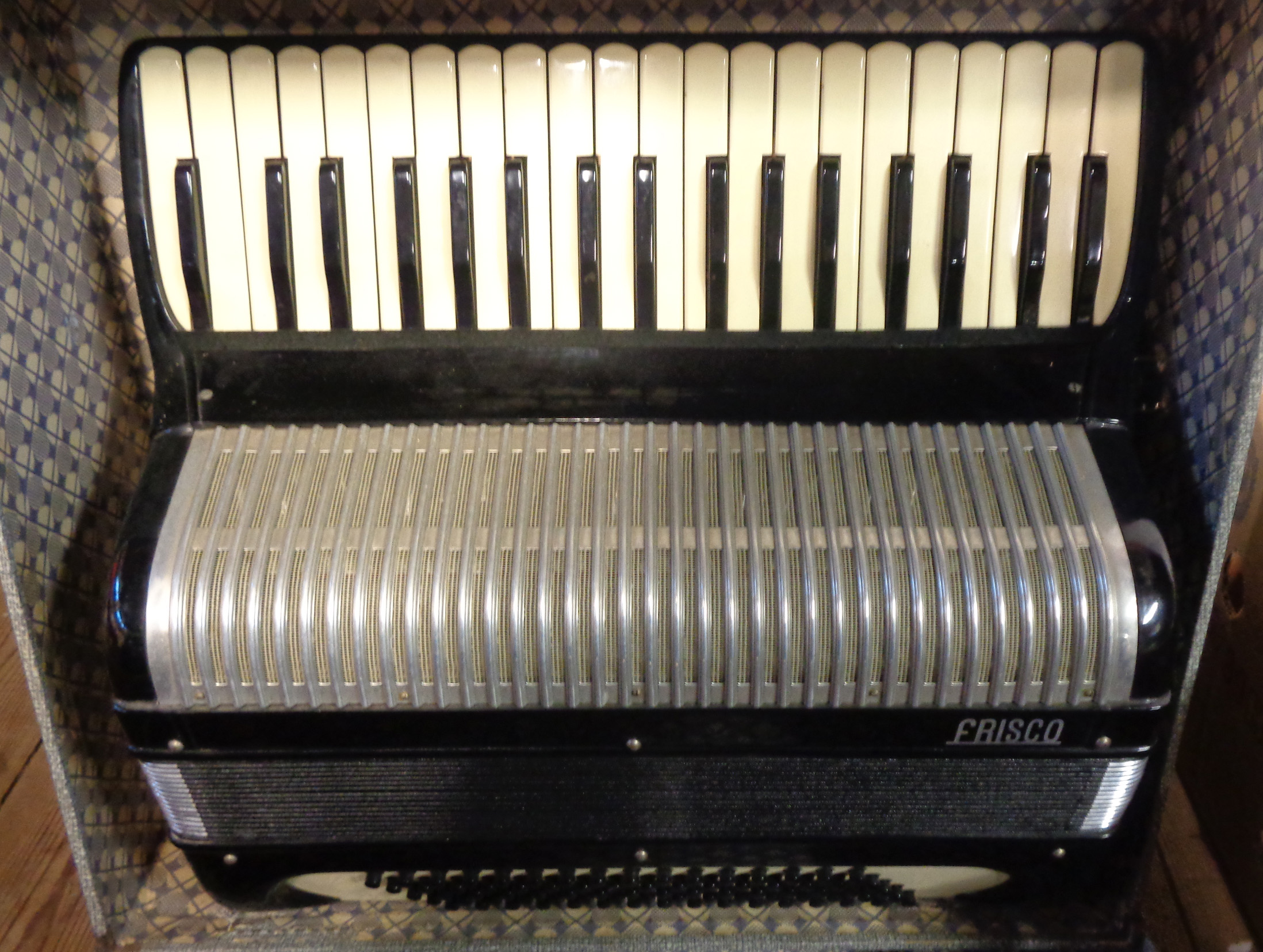 A hard cased Frisco piano accordion