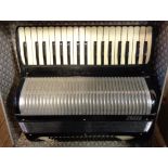 A hard cased Frisco piano accordion