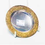 A 9cm diameter Stuart Devlin silver gilt pin tray with granulated rim - London 1972