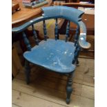 An old later painted wood smoker's bow elbow chair with moulded solid seat, set on turned supports