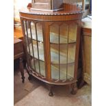 A 108cm 1920's mahogany bow front display cabinet with low raised back and material lined interior