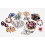 A collection of vintage costume jewellery and other brooches including a 1950's S.J. Ltd. silver