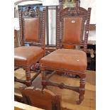 A set of six late Victorian heavy oak framed panel back dining chairs with lion mask decoration to