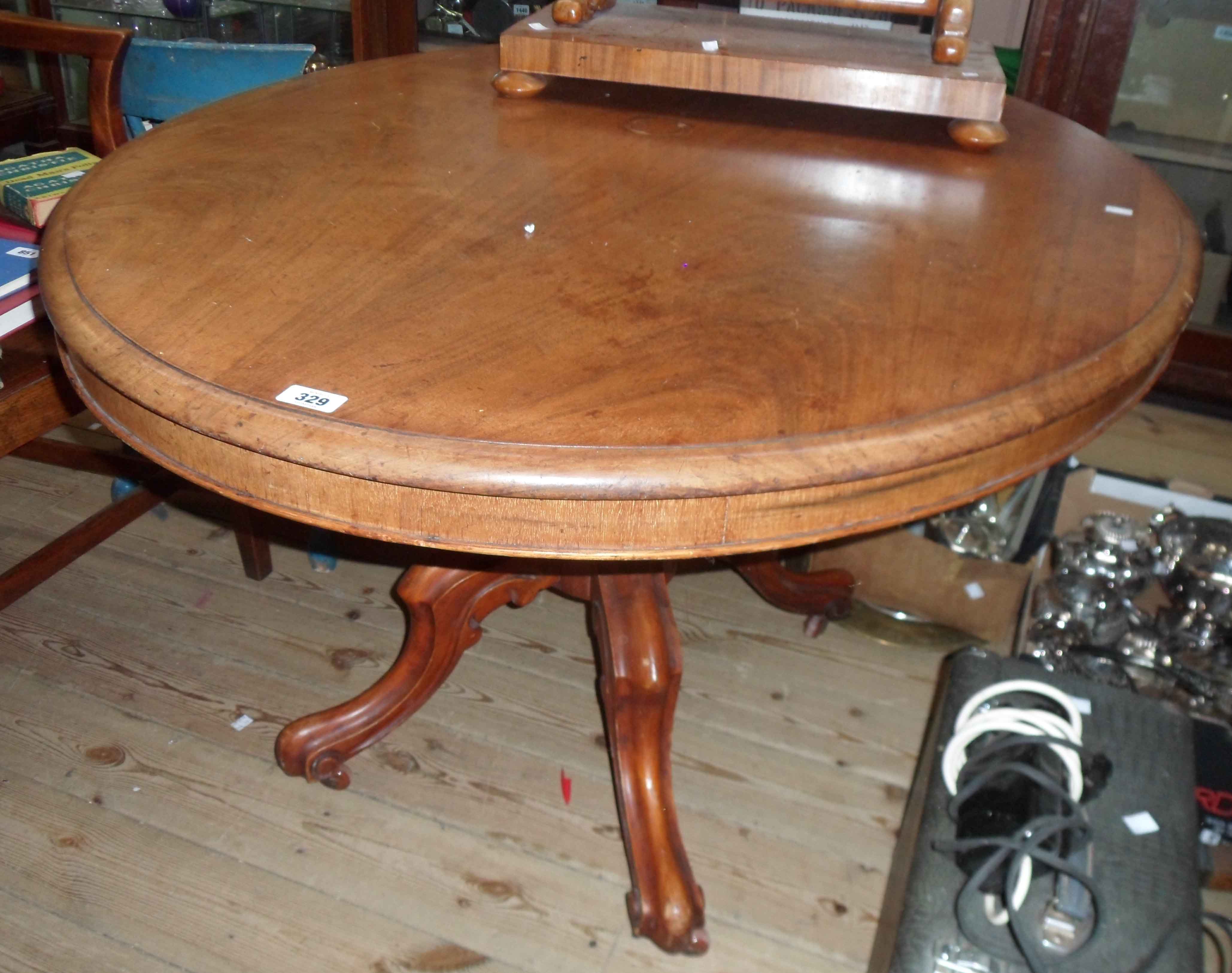 A 1.34m Victorian mahogany oval tilt-top loo table, set on massive turned pillar and cabriole scroll
