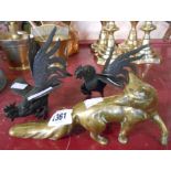 A pair of metal figurines of fighting cockerels and a brass fox