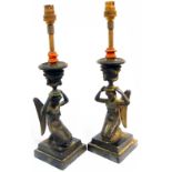 A pair of bronze candleticks in the form of kneeling angels with urns on their heads, set on stepped