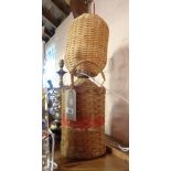 A wicker clad stoneware flagon - as a lamp with wicker shade