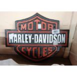 A reproduction painted cast iron Harley Davidson sign