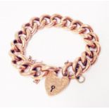 A marked 9ct rose metal kerb-link bracelet with engraved heart shaped padlock and safety chain