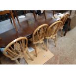 A set of four 20th Century hoop stick back kitchen chairs with solid sectional elm seats, set on