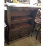 A 91cm 20th Century oak two shelf open bookcase with decorative apron to top and pair of panelled