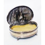 A silver kidney shaped ring box with piano hinged lid, set on paw pattern feet - worn