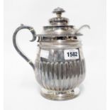 A 21.5cm late Georgian silver hot water jug of semi-reeded design by Michael Starkey - London 1819