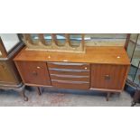 A 1.4m retro G-plan teak sideboard with three central drawers and flanking cupboard doors, set on