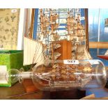 A pair of wooden bookends with model Mayflower, a modern HMS Victory ship in a bottle, and a