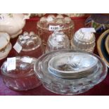 Seven glass jelly moulds and fourteen metal jelly moulds