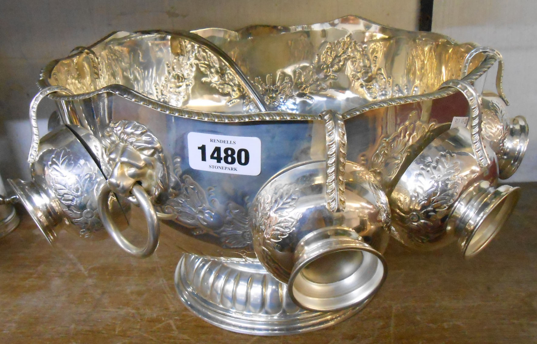 A silver plated punch bowl with lion mask ring handles and six cups, a parcel gilt kings pattern