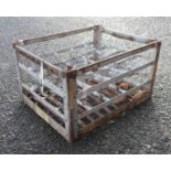 A vintage French metal twenty bottle crate bearing various labels including Chateau Perenne