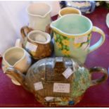 Six pieces of E. Radford pottery comprising cottage moulded teapot and cream jug, and floral