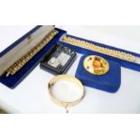 A gold plated clasp bracelet - sold with four items of boxed costume jewellery including simulated