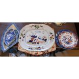 A Victorian ironstone meat plate, a Wedgwood blue and white transfer printed plate, a large