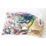 A bag containing a quantity of bead necklaces, other loose beads, Dmar simulated pearls, etc.