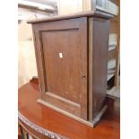 A 42cm early 20th Century oak table top cabinet with shelves and three graduated drawer fitted