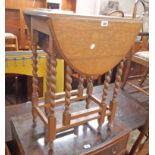 A 60cm 20th Century oak gateleg table, set on barley twist supports