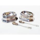 A pair of late Georgian white metal table salts of faceted design, bearing engraved initials -