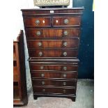 A 74cm reproduction mahogany chest on chest with two short and three long drawers over brushing