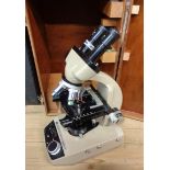 A boxed Vickers Instruments Complan binocular microscope with illuminated base