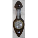 A stained oak Gothic style cased barometer/thermometer with aneroid works