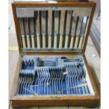 A vintage oak canteen containing a part six place setting of silver plated cutlery and other loose