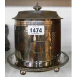 An early 20th Century silver plated biscuit barrel with hinged lid, engraved decoration and ball
