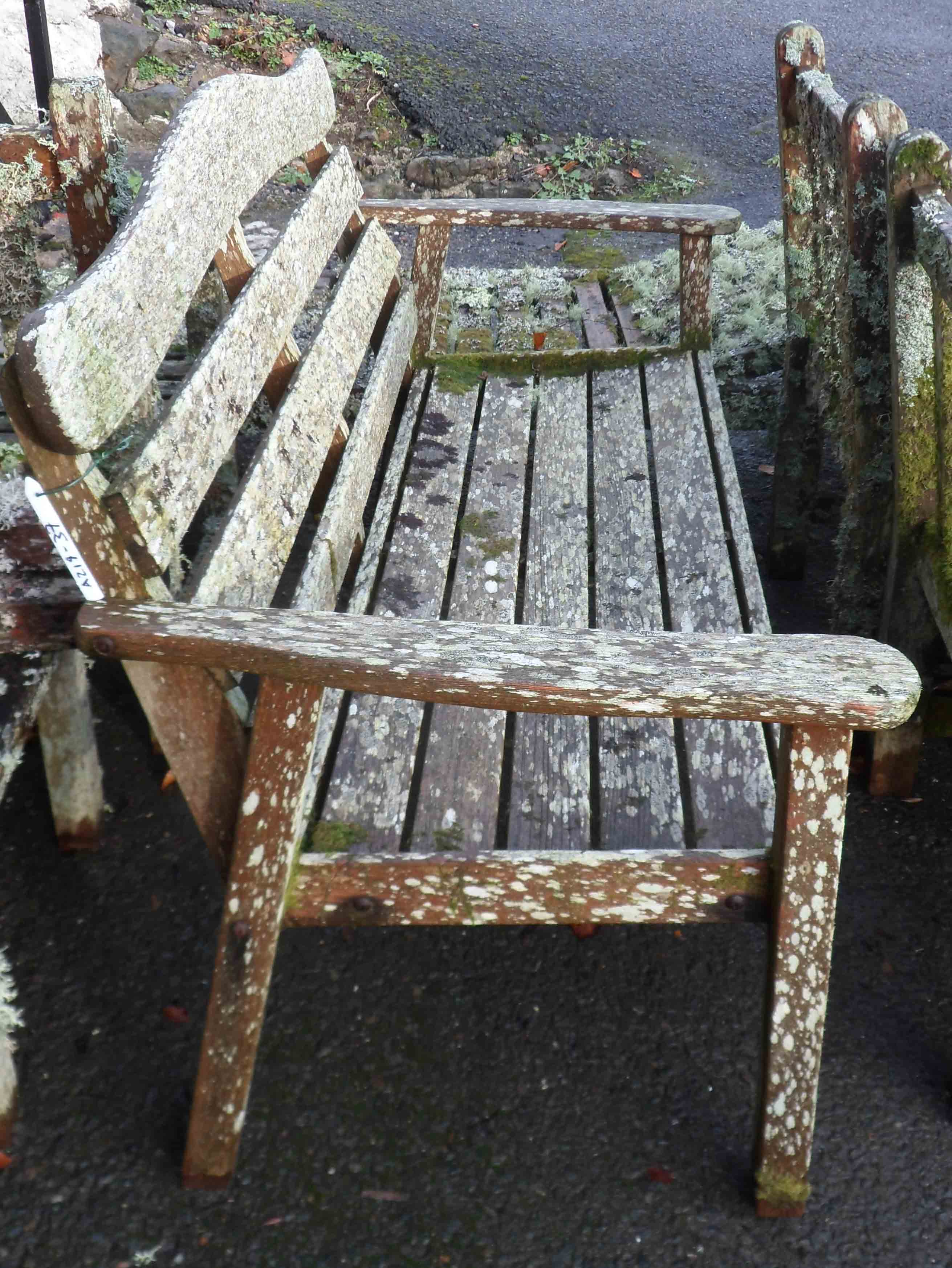 A Hartman Prestige teak garden bench covered in lichen