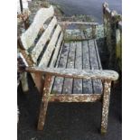 A Hartman Prestige teak garden bench covered in lichen