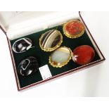 Six hardstone brooches including banded agate