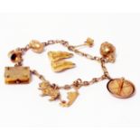 A marked 375 charm bracelet, set with hallmarked 9ct. gold and other marked charms - sold with a