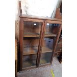 A 67cm late Victorian pitch pine wall mounted three shelf book cabinet enclosed by a pair of