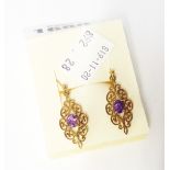 A pair of hallmarked 375 gold fancy drop ear-rings with amethyst to centre