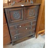 A 78cm 20th Century stained oak cabinet in the antique style with pair of carved panel doors and