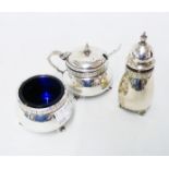 A silver three piece condiment set with cast rims, blue glass liners and scroll feet - Birmingham