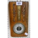 An early 20th Century polished wood cased wall barometer/thermometer with visible aneroid works to