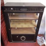 A 76.5cm late Victorian ebonised display cabinet with material lined shelves enclosed by a part
